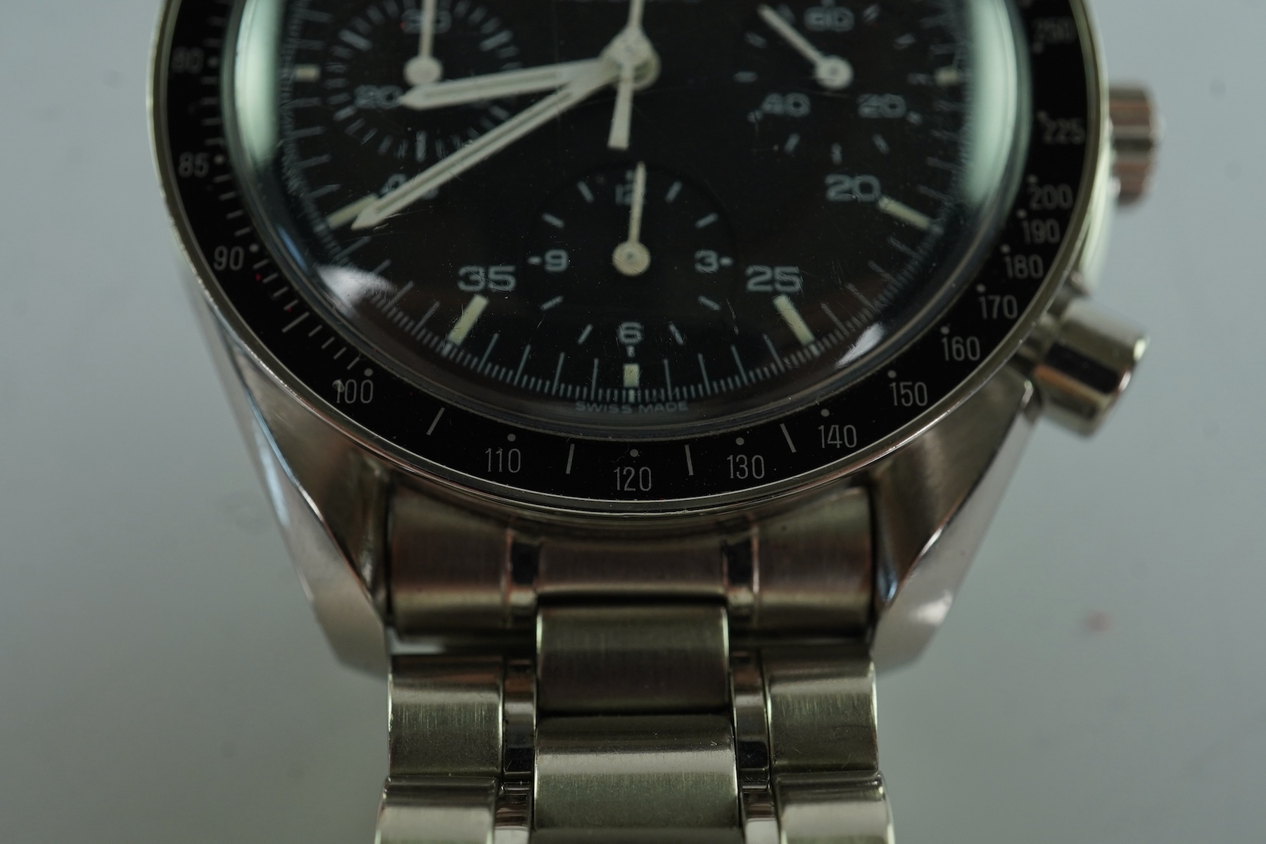 A gentleman's late 1990's stainless steel Omega Speedmaster automatic wrist watch, with box and three pamphlets